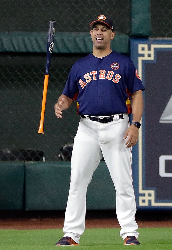 In this Oct. 20 file photo, Astros bench coach Alex Cora flips a bat before Game 6 of the American League Championship Series against the Yankees in Houston. The Red Sox announced Sunday that Cora has been hired to be their new manager.