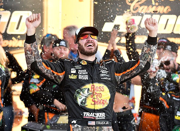 Martin Truex Jr. celebrates in victory lane after winning Sunday's NASCAR Cup Series race at Kansas Speedway in Kansas City, Kan.