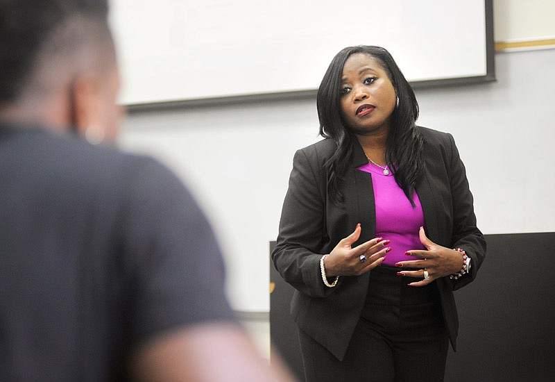 Business instructor Andria Hendricks answers a student's question during her class at Lincoln University. She is in the process of earning her doctorate degree.