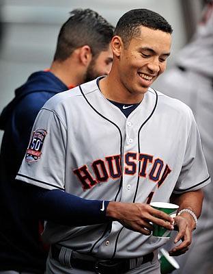 This June 8, 2015, file photo, shows  Carlos Correa laughing in the dugout with his Astros teammates after his first major league at-bat against the White Sox in Chicago.