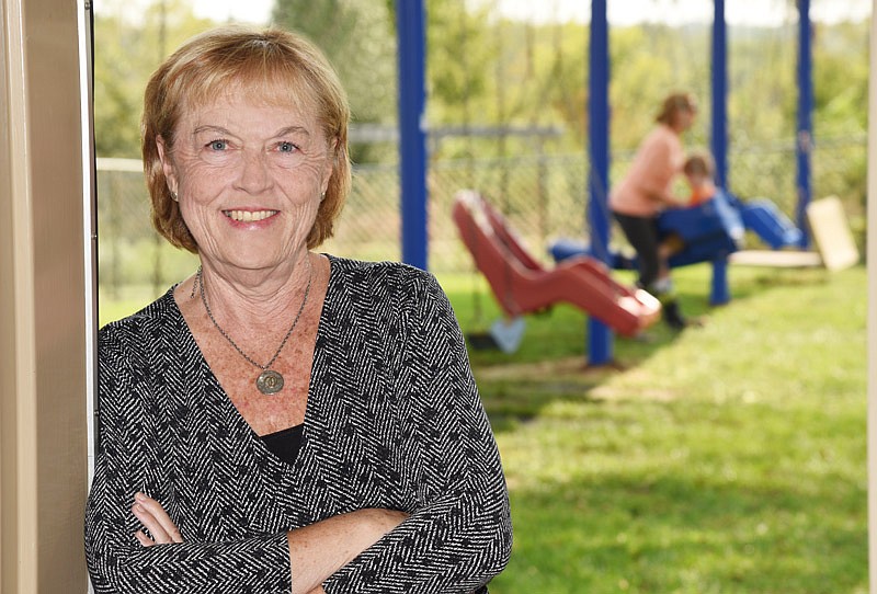 Debbie Hamler, executive director of the Special Learning Center, with the center's playground in the background.