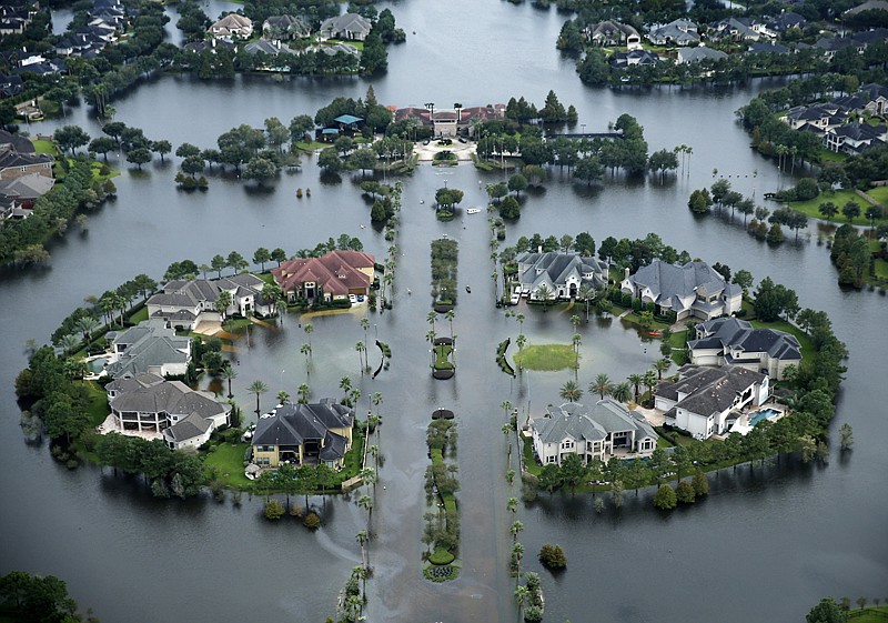 Floodwaters rise at the Lakes on Eldridge North neighborhood near the Addicks Reservoir on Aug. 30 in Houston. Hurricane Harvey inundated the Houston area with several feet of rain. Lawmakers are looking to rehabilitate the National Flood Insurance Program. 


