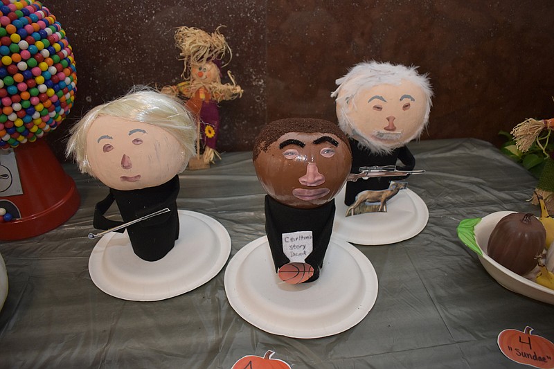 A tribute to Miller County's three circuit court judges displayed Wednesday included pumpkins carved by Penny Kilcrease in the image of judges Kirk Johnson, left, Carlton Jones and Brent Haltom. The decorated pumpkins are displayed in the lobby of the county courthouse in Texarkana, Ark., as part of the Halloween celebration.