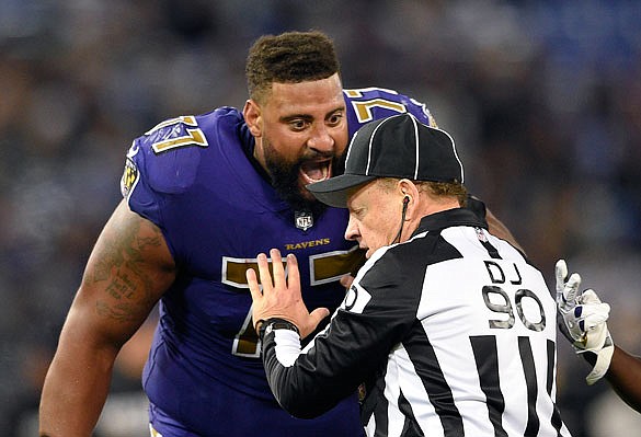 Ravens offensive tackle Austin Howard speaks with official Mike Spanier in the second half of Thursday night's game against the Dolphins in Baltimore.
