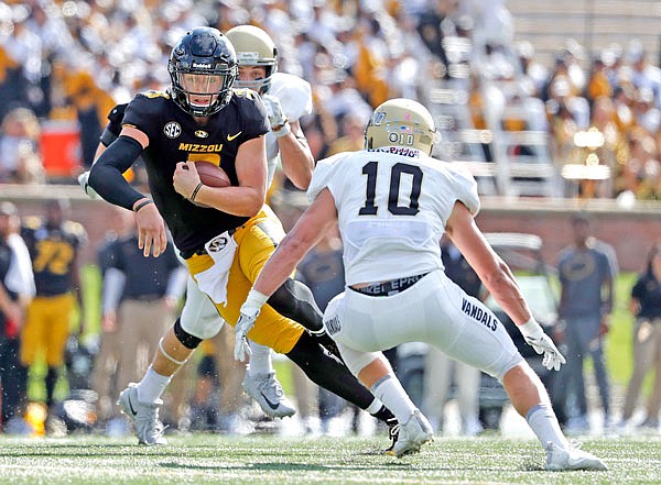 Missouri quarterback Drew Lock runs with the ball past Idaho linebacker Ty Graham during the second half of last Saturday's game at Faurot Field.
