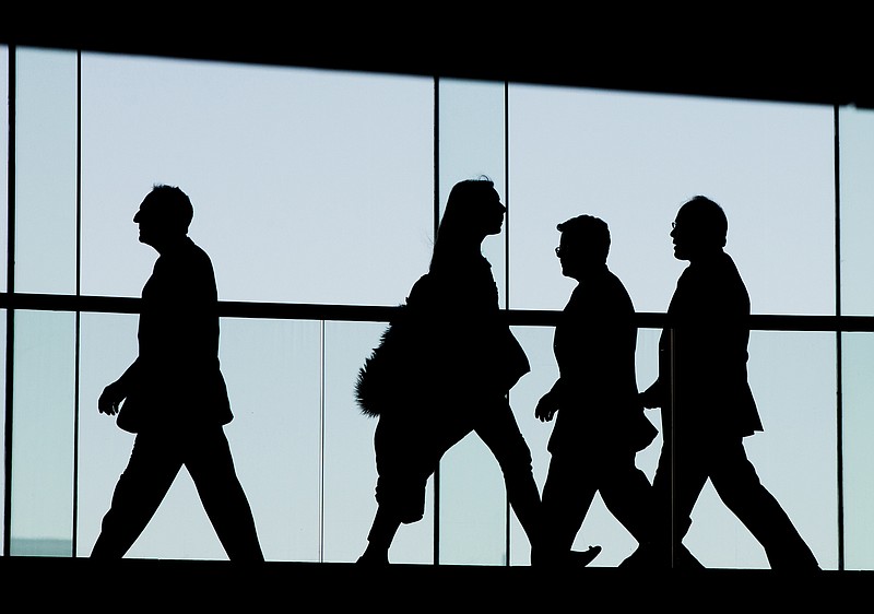 FILE - In this Tuesday, Jan. 5, 2016, file photo, people walk at the National Constitution Center in Philadelphia. Congress is looking for ways to raise revenue to help pay for the big tax cuts it wants to extend to businesses and workers, and one potential target reportedly has been the tax-deferred contributions that workers make to their 401(k) accounts. (AP Photo/Matt Rourk, File)