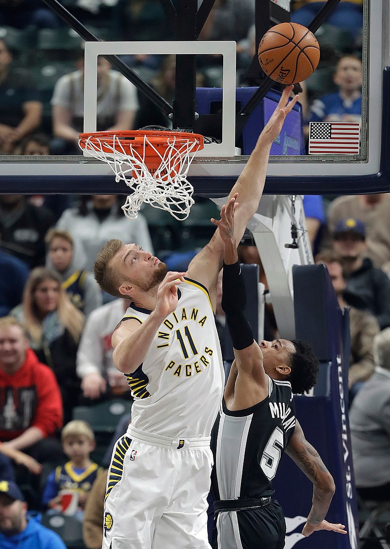 San Antonio Spurs' Dejounte Murray , right, shoots over Indiana Pacers' Domantas Sabonis (11) during the first half of an NBA basketball game, Sunday, Oct. 29, 2017, in Indianapolis. 