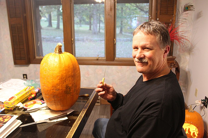Chris Heffner at his pumpkin-carving station.