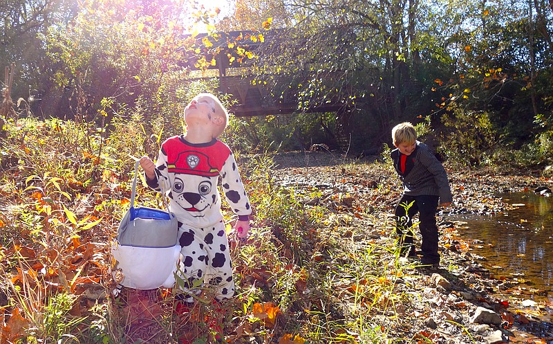 Richard Atterberry, left, Ashton Bucholz and Anna Atterberry head towards Stinson Creek to pick up trash during Sunday's Scream Clean. In the background are Emily Davidson, left, and Andrea Ramos, students at Westminster College who volunteered to educate kids about watersheds and the creatures that live in the creek.