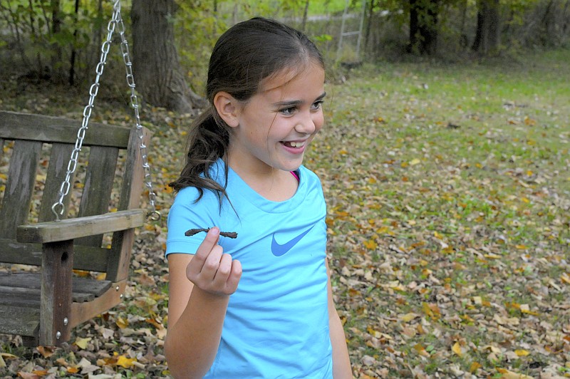 <p>Democrat photo/Michelle Brooks</p><p>Sophie McKinney shows off a nail she found buried in the dirt and unearthed, thanks to her metal detector.</p>