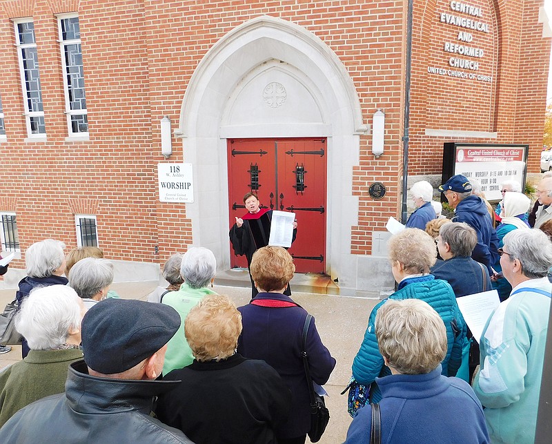 Rev. Stephen Buchholz, former pastor of Central United Church of Christ, holds the list of 95 issues of difference before "posting" them on the door prior to a talk about the Reformation during a presentation at the southside church.