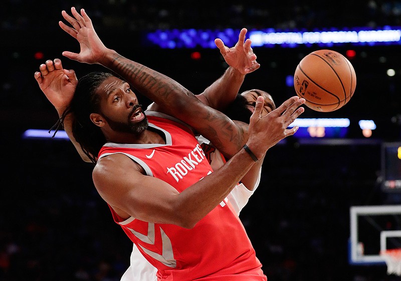 Houston Rockets' Nene Hilario, left, fights for control of the ball with New York Knicks' Kyle O'Quinn during the first half of an NBA basketball game Wednesday, Nov. 1, 2017, in New York. 