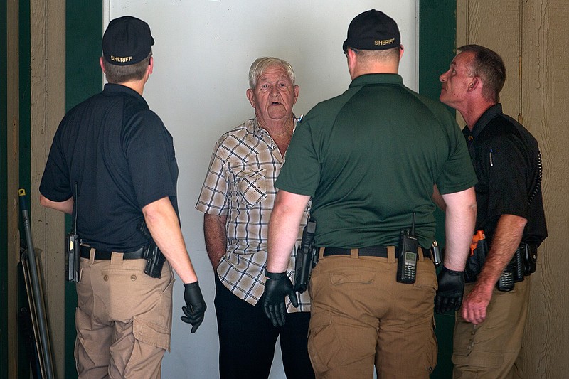 Buddy Cates, 81, talks with Miller County investigators after fatally shooting an burglary supect in his home Thursday in Genoa, Ark. According to Cates, this was the sixth time in 10 months he was robbed. Cates said he was tied up and beaten during a previous burglary. Cates said the prior attack prompted him to start carrying a gun at all times. "I will not go to sleep without a gun," he said. The alleged burglar later died at the hospital.