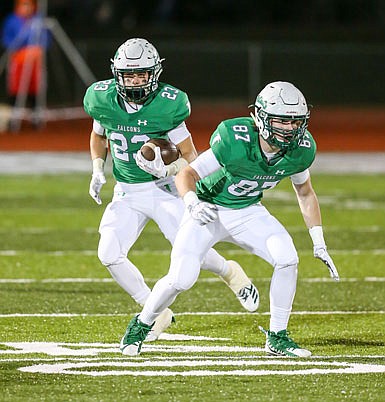 Ethan Luebbering of the Blair Oaks Falcons follows the block of Grant Laune during last Friday night's game against Wright City in Wardsville.