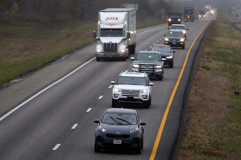 In this photo made Wednesday, Nov. 1, 2017, a driver stays in the passing lane as traffic accumulates behind along I-70 in Montgomery County, Mo. Many states have laws against driving in the left lane except for passing or turning left, which are often ignored by drivers, leading to annoying and dangerous bottlenecks that some experts say are as bad as driving too fast because people get trapped behind and become frustrated prompting some to drive more aggressively. (AP Photo/Jeff Roberson)