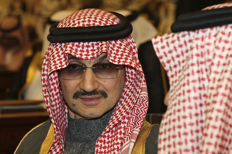 FILE- In this Sunday, March 7, 2010 file photo, Saudi billionaire Prince Alwaleed bin Talal al-Saud attends the speech of King Abdullah bin Abdul Aziz al-Saud of Saudi Arabia, at the Saudi Shura "consultative" council in Riyadh, Saudi Arabia.  Saudi Arabia has arrested dozens of princes and former government ministers, including a well-known billionaire with extensive holdings in Western companies, as part of a sweeping anti-corruption probe, further cementing King Salman and his crown prince son's control of the kingdom. A high-level employee at Prince Alwaleed bin Talal's Kingdom Holding Company told The Associated Press that the royal was among those detained overnight Saturday, Nov. 4, 2017.  (AP Photo/Hassan Ammar, File)