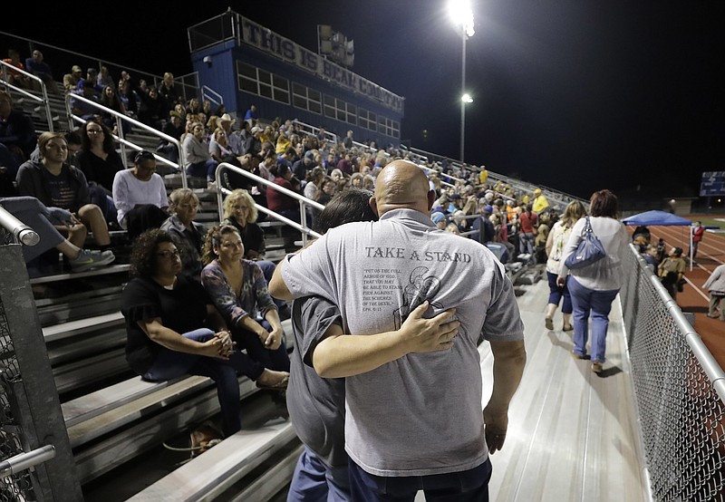 Attendees make their way through the stands of a football stadium before a vigil for the First Baptist Church shooting victims Tuesday, Nov. 7, 2017, in La Vernia, Texas. A man opened fire inside the church in the small South Texas community on Sunday, killing more than two dozen and injuring others. (AP Photo/David J. Phillip)