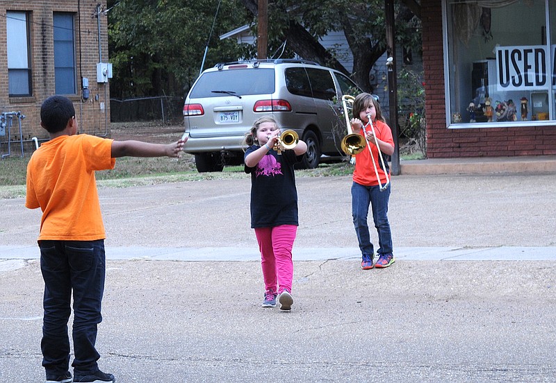 Braiden Fahrney, 9, from left, Alizabeth White, 7, and Kaiden Fahrney, 10, practice to be in the Atlanta Middle School band program.