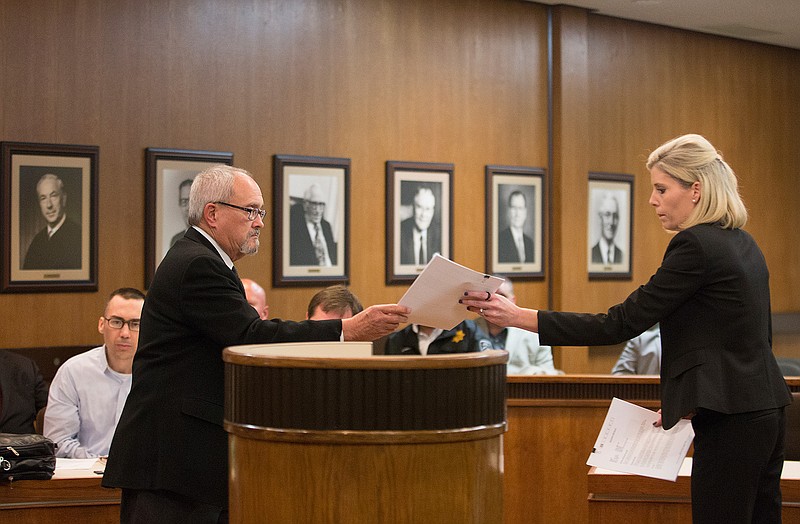Mount Pleasant, Texas, defense attorney Mac Cobb hands documents to Assistant District Attorney Kelley Crisp at a hearing Wednesday afternoon before 102nd District Judge Bobby Lockhart during a one-day recess in the sentencing phase of Billy Joel Tracy's capital murder trial. The state rested its case Tuesday. The defense is expected to begin calling witnesses today. Tracy faces a possible death sentence in the July 2015 beating death of Correctional Officer Timothy Davison.
