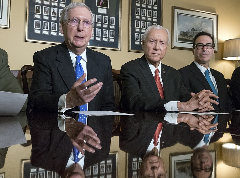 From left, Senate Majority Leader Mitch McConnell, R-Ky., Senate Finance Committee Chairman Orrin Hatch, R-Utah, and Treasury Secretary Steven Mnuchin, make statements to reporters as work gets underway on the Senate's version of the GOP tax reform bill, on Capitol Hill in Washington, Thursday, Nov. 9, 2017. (AP Photo/J. Scott Applewhite)