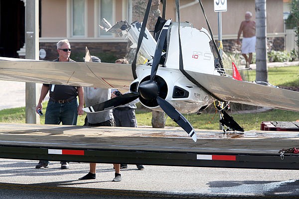 The remains of an ultralight airplane are moved from a boat ramp Wednesday in the Gulf Harbors neighborhood of New Port Richey, Fla. The plane, which belonged to Roy Halladay, had just been removed from the shallow waters off Ben Pilot Point in New Port Richey where it crashed Tuesday.