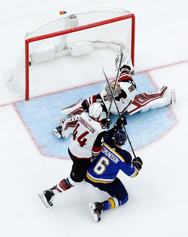 Joel Edmundson of the Blues scores past Coyotes goalie Antti Raanta and Kevin Connauton during the second period of Thursday night's game in St. Louis.