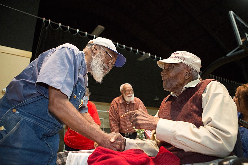 Richard Armstrong visits with Walter Lee Moore on Friday at the Texarkana Gazette-sponsored Veterans Day ceremony at Williams Memorial United Methodist Church. Moore, who turned 104 years old Friday, served in the Navy from 1942-46 and is a Pearl Harbor survivor. Armstrong was in the Air Force from 1962-66.