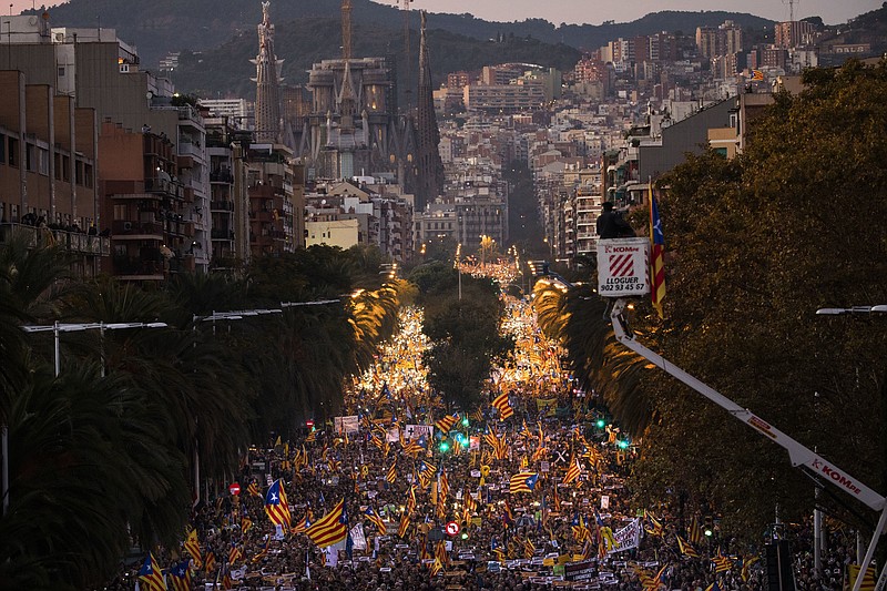 Backdropped by the Sagrada Familia church, demonstrators march during a protest calling for the release of Catalan jailed politicians, in Barcelona, Spain, on Saturday, Nov 11, 2017. Eight members of the now-defunct Catalan government remain jailed in a related rebellion case. Former regional president Carles Puigdemont and four other ex-cabinet members fled to Belgium where they are fighting extradition. (AP Photo/Emilio Morenatti)