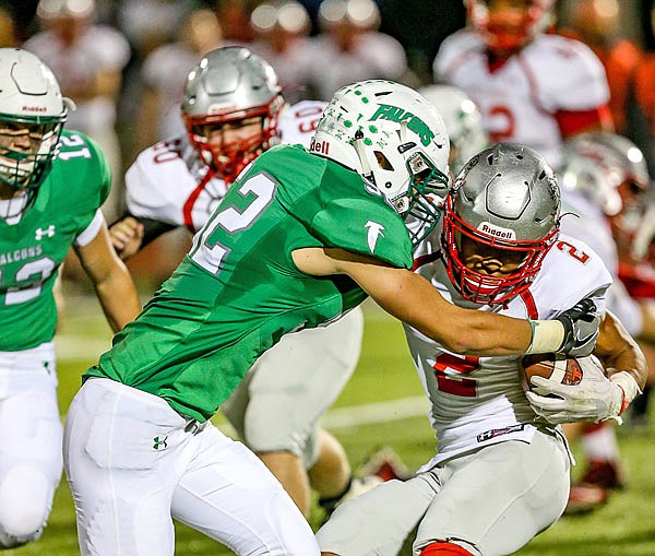 Jared Lootens of Blair Oaks Falcons wraps up Cameron Holman of Mexico during last Friday night's Class 3 District 6 championship game at the Falcon Athletic Complex in Wardsville.