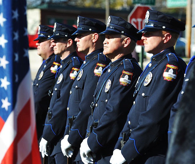 The Jefferson City Police Department Honor Guard awaits their call for the 21-gun salute Friday near the conclusion of Jefferson City East Side Business Association's Veteran Tribute at Freedom Corner. 