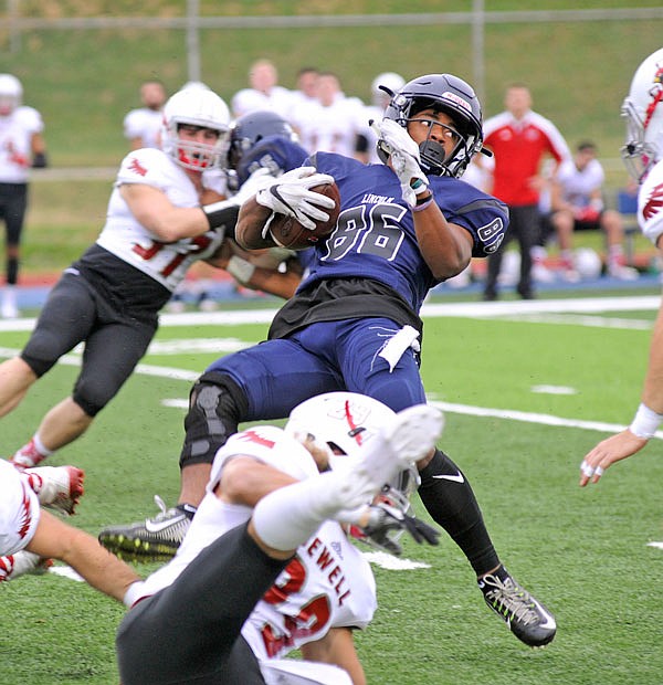 A'Jani Johnson of Lincoln attempts to avoid a hit during last Saturday's game against William Jewell at Dwight T. Reed Stadium.