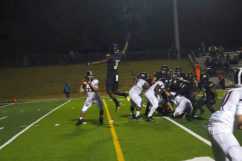  Pleasant Grove's Xavier Benson (3) leaps to block a pass from Gladewater's Daniel Badger (13) during the second half of a football game Friday night at Hawk Stadium.