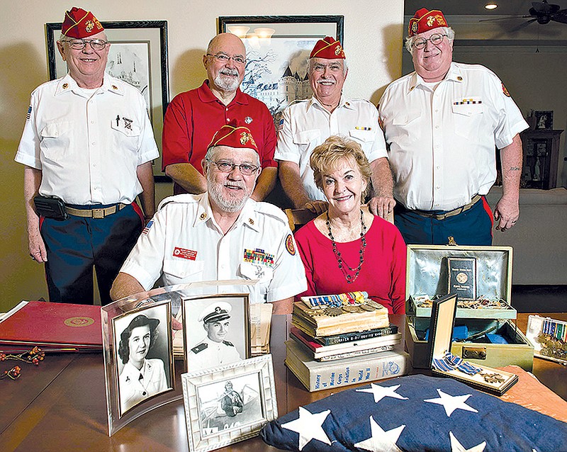 In this Thursday, Nov. 2, 2017 photo, members of the Marine Corps League's Rose City Detachment 1354 surround Marty Bruce at her home in Tyler, Texas. Bruce requested help to organize Navy and Marine Corps items passed down to her from her mother and father. Pictured from left back row,  J.B. Robinson, Hue Adams, Jesse McCall, Donald Monn and front row, Chuck Tompkins and Bruce. 