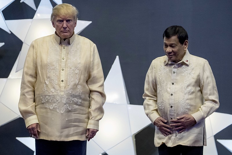 President Donald Trump and Philippines President Rodrigo Duterte, right, join other leaders, not pictured, for a family photo at an ASEAN Summit dinner at the SMX Convention Center, Sunday, Nov. 12, 2017, in Manila, Philippines. (AP Photo/Andrew Harnik)