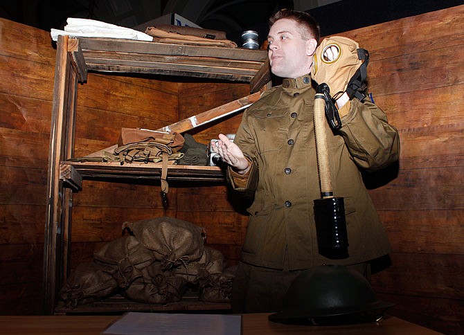 Lucas Schwartze explains the significance of gas masks and the dangers that troops faced when confronting gas in battle during World War I as a part of "Missouri and the Great War" on Saturday at the Missouri State Museum. Schwartze was dressed as a WWI Quartermaster, whose role was to hand out simple supplies to troops as they were leaving basic training.