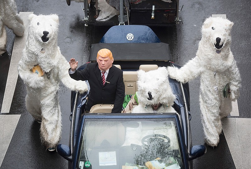 Demonstrators costumed as U.S. President Donald Trump and polar bears protest against the climate change during climate conference COP in Bonn, western Germany, Saturday, Nov. 11, 2017. 
