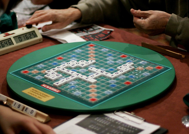 FILE - In this Thursday, Nov. 17, 2005 file photo, competitors take part in the World Scrabble Championships at an hotel in north west London. The Association of British Scrabble players has banned one of its star players, Allan Simmons, for three years after an independent investigation concluded that he had broken the rules of the popular game, it was reported on Monday, Nov. 13, 2017. (AP Photo/Matt Dunham, File)