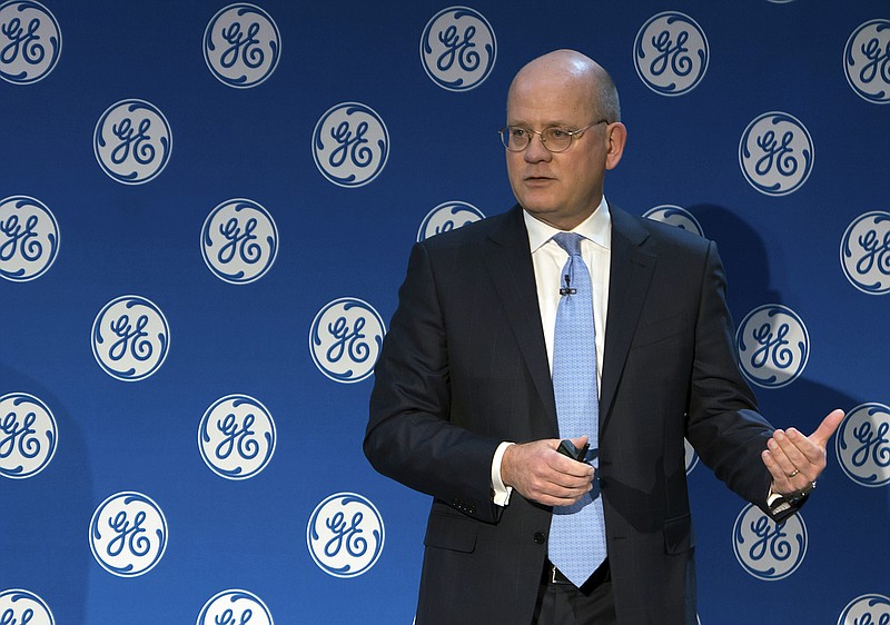 In this Monday, Nov. 13, 2017, photo provided by General Electric, GE Chairman and CEO John Flannery addresses investors at a meeting in New York. Flannery said the company is weighing the future of its transportation, industrial, and lighting businesses so that it can focus more intently on its most profitable divisions. (Eli Kabillio/General Electric via AP)
