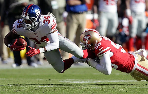 Giants running back Shane Vereen (left) is tackled by 49ers linebacker Reuben Foster during the first half of Sunday's game in Santa Clara, Calif.