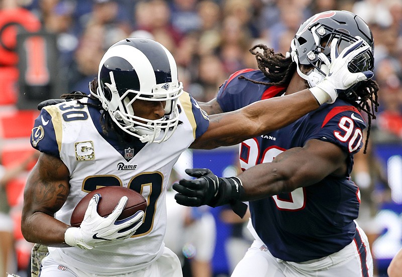 Los Angeles Rams running back Todd Gurley pushes away Houston Texans outside linebacker Jadeveon Clowney during the first half of an NFL football game Sunday in Los Angeles. 