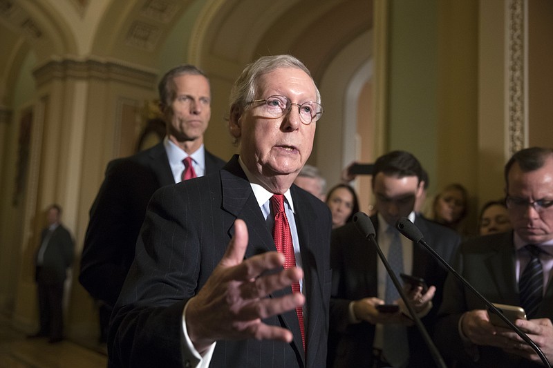 Senate Majority Leader Mitch McConnell, R-Ky., joined at rear by Sen. John Thune, R-S.D., tells reporters that he has spoken to President Donald Trump and other leaders about the Alabama Senate race and the allegations of sexual misconduct against GOP candidate Roy Moore, on Capitol Hill in Washington, Tuesday, Nov. 14, 2017. McConnell and other Republicans have called for Moore to step aside. (AP Photo/J. Scott Applewhite)