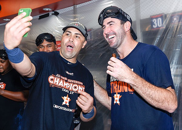 In this Sept. 17 file photo, Astros designated hitter Carlos Beltran and pitcher Justin Verlander celebrate the team's win against the Mariners to clinch the AL West crown in Houston.