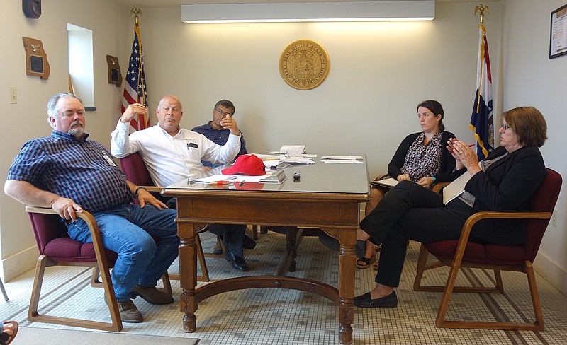 In June, commissioners Randy Kleindienst, left, Gary Jungermann and Roger Fischer met with Boone County Court Administrator Mary Epping and Judge Sue Crane, among others, to discuss solutions for the county's rapidly depleting Juvenile Justice Center care budget.