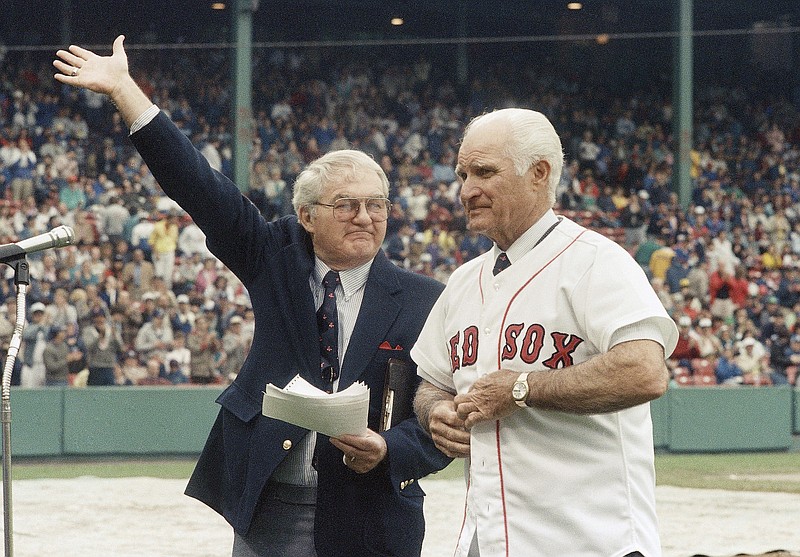 In this May 21, 1988, file photo, the radio voice of the Boston Red Sox, Kent Coleman, left, presents former Red Sox second baseman Bobby Doerr to the crowd at Fenway Park during a ceremony to retire his No. 1. Doerr, a Hall of Fame second baseman who was dubbed the "silent captain" by longtime Red Sox teammate and life-long friend Ted Williams, has died. He was 99.