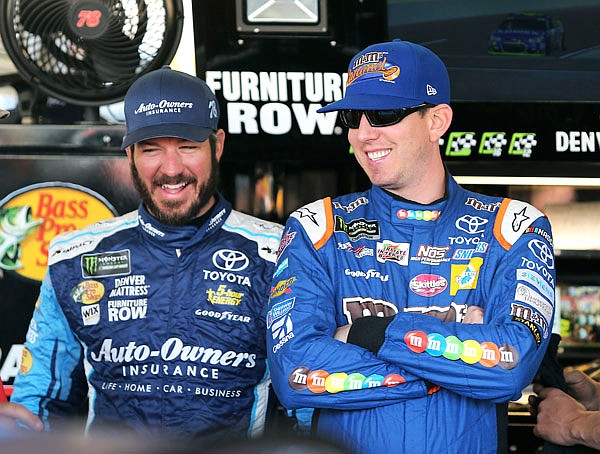 Kyle Busch (right) and Martin Truex Jr. laugh inside the garage area Friday before practice for the NASCAR Cup Series race at Phoenix International Raceway in Avondale, Ariz. 