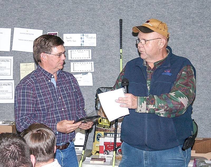 <p>Democrat photos/David A. Wilson</p><p>Above: At the Moniteau County Cattlemen’s Dinner and Auction, President David Gier presents an “Outstanding Cattlemen’s Award” plaque to Dr. Mark Oerly, DVM. The award was presented in thanks for his many years of support to the association.</p><p>Right: Auctioneer Grant Petree calls for bids on an item at the Moniteau County Cattlemen’s Dinner and Auction.</p>