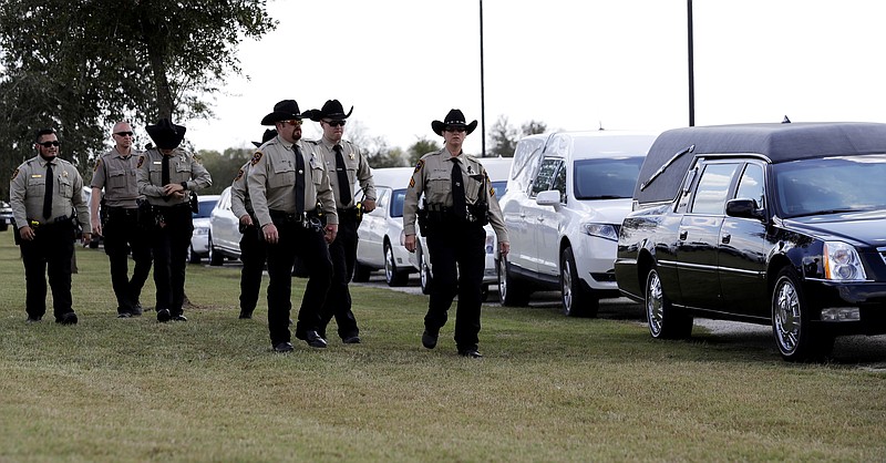 Mourners arrive at the Floresville Event Center to attend a funeral for members of the Holcombe family who were killed in the Sutherland Springs Baptist Church shooting, Wednesday, Nov. 15, 2017, in Floresville, Texas. A man opened fire inside the church in the small South Texas community Sunday, Nov. 5, killing more than two dozen. (AP Photo/Eric Gay)