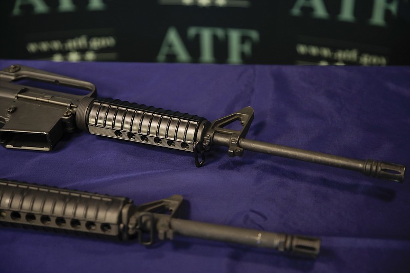 In this Tuesday, Aug. 29, 2017, photo, homemade rifles are displayed on a table at an ATF field office in Glendale, Calif. Police say Kevin Neal, who was barred from having guns because of a restraining order, made the two high-powered rifles he used in his shooting rampage in Northern California on Tuesday, Nov. 14. (AP Photo/Jae C. Hong)