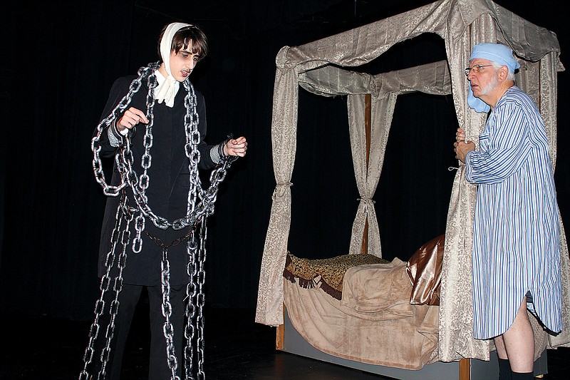 Caleb Bennett, as the ghost of Jacob Marley, left, and Josh Morriss III as Ebenezer Scrooge, rehearse for Silvermoon Children's Theatre's production of "A Christmas Carol." SCT continues the play with shows tonight, Saturday and Sunday.