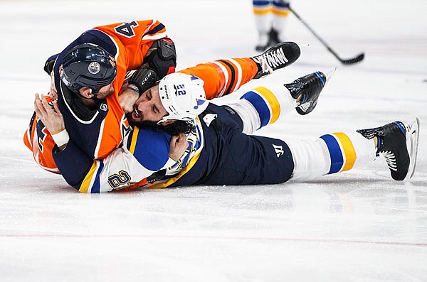 Chris Thorburn of the Blues fights Zack Kassian of the Oilers during Thursday night's game in Edmonton, Alberta.